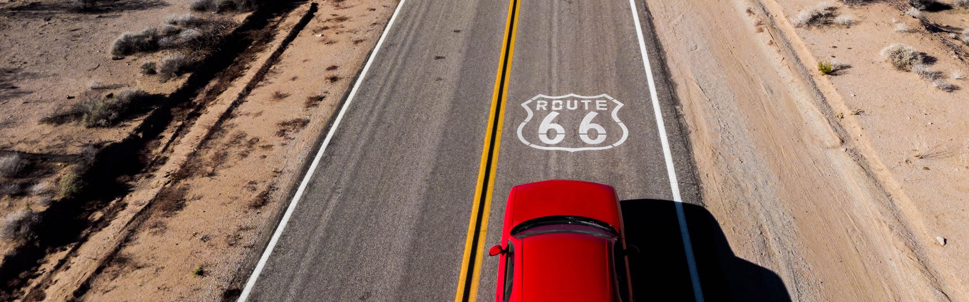 Red car on road trip down route 66