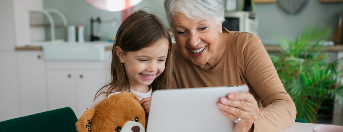 Grandma and grandchild having fun using a tablet