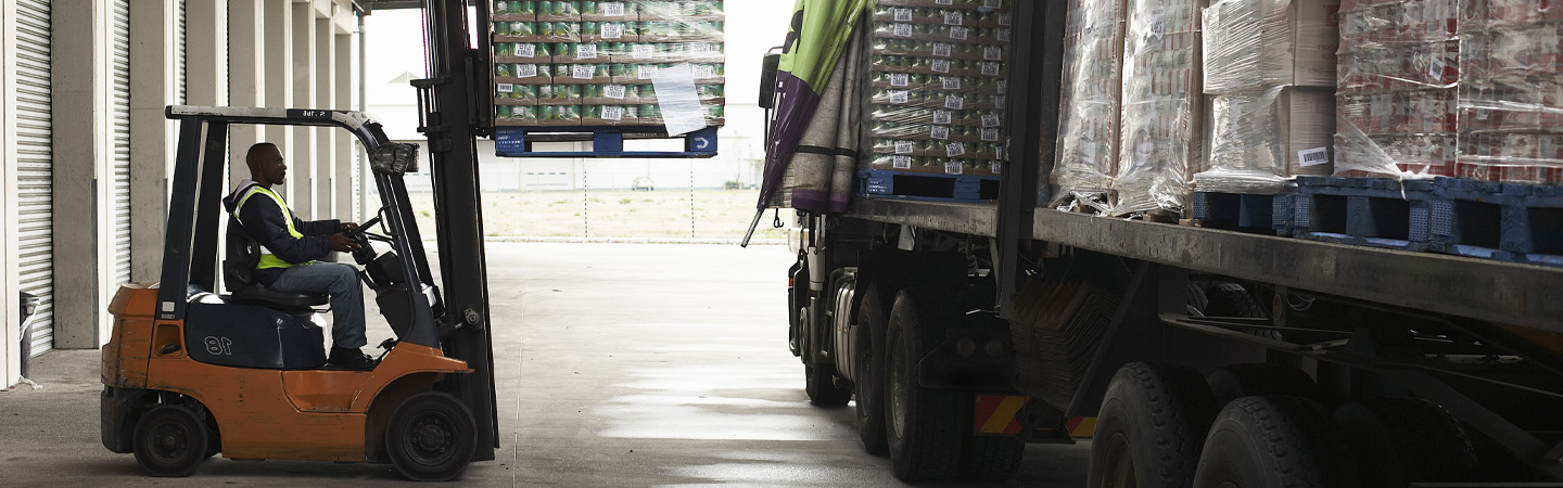 Man driving forklift in warehouse