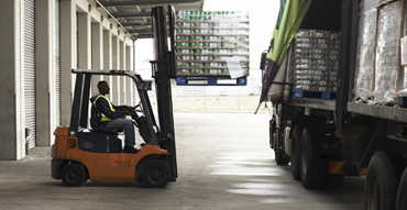 Man driving forklift in warehouse