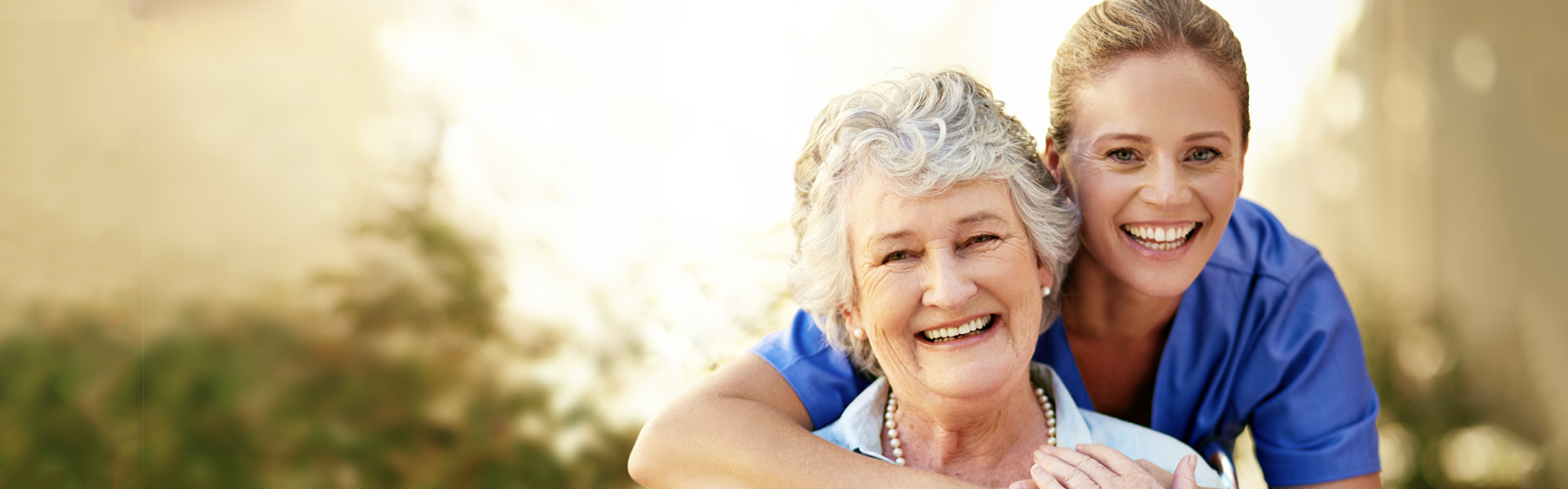 Younger and older women embracing and smiling