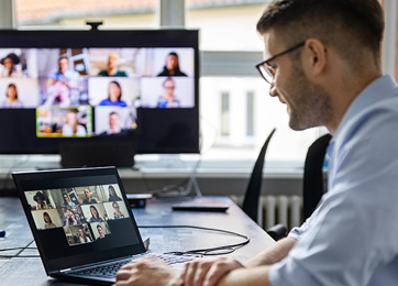 Man sitting at desk on a virtual meeting