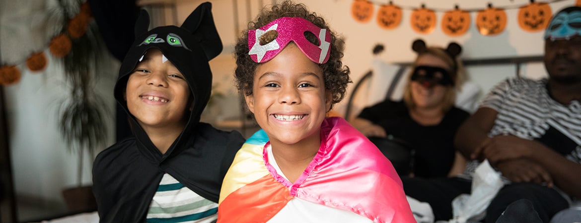 Two children and parents celebrating Halloween at home