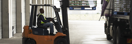 Man driving forklift in warehouse