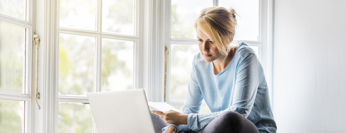 Woman using laptop to handle her finances