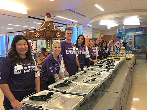 Photo of credit union employees lined up at CHOC to serve food