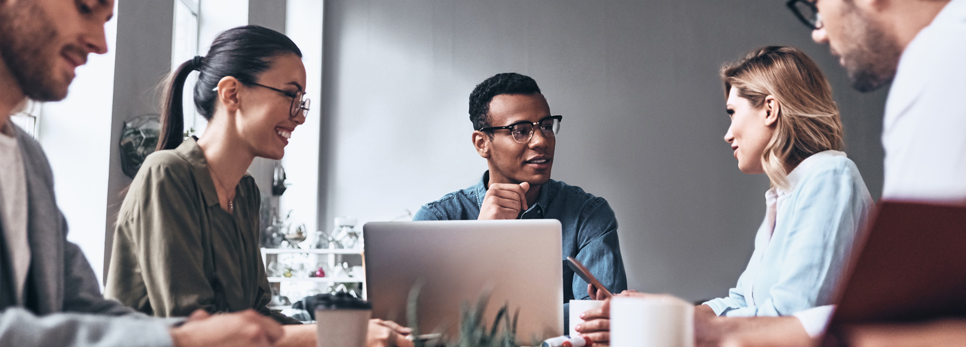 Group of co-workers sitting at a conference room table