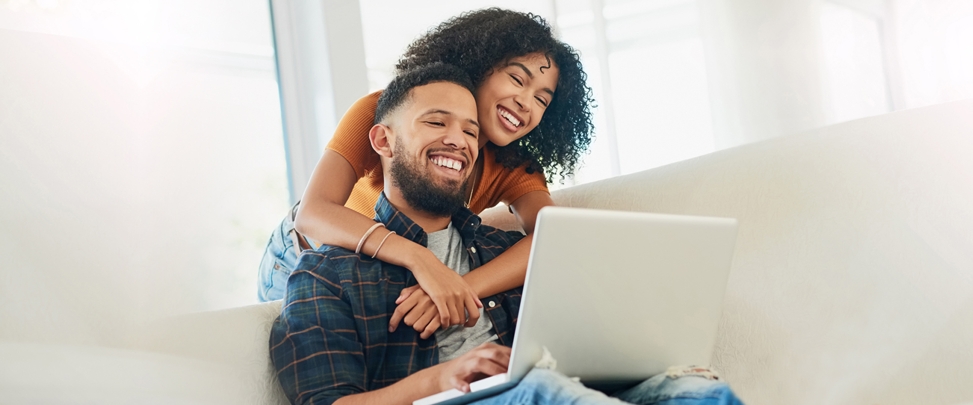 Happy couple signing up for a new Orange County's Credit Union account from home