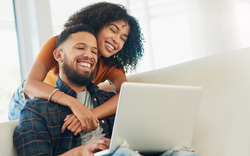 Happy couple signing up for a new Orange County's Credit Union account from home