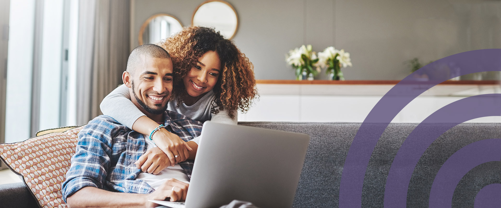 Smiling Couple Looking At Open Laptop