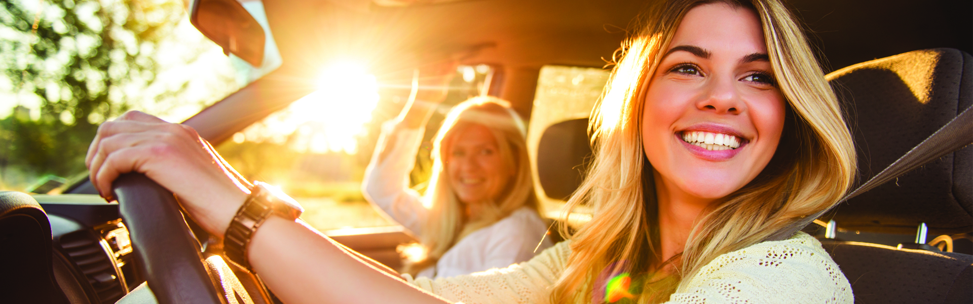 Female driving a car smiling