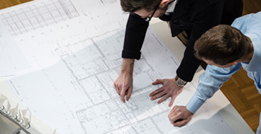 Contractors reviewing blueprints