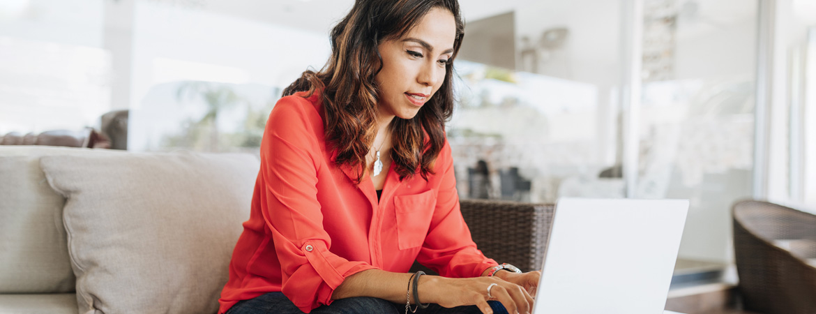 Photo of woman using online banking to protect her checking account