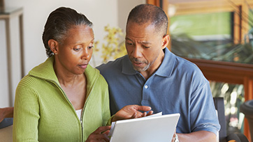 Couple reviewing account documents to ensure everything is in order security-wise