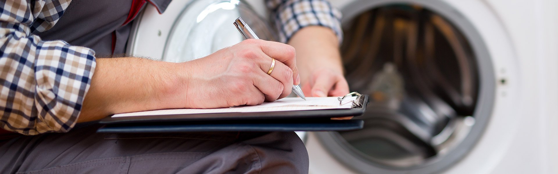 Photo of a person filling out a service agreement for the repair of a home appliance