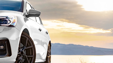 White car with sunset in background