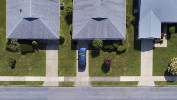 Aerial view of neighborhood of homes with drive ways lined up
