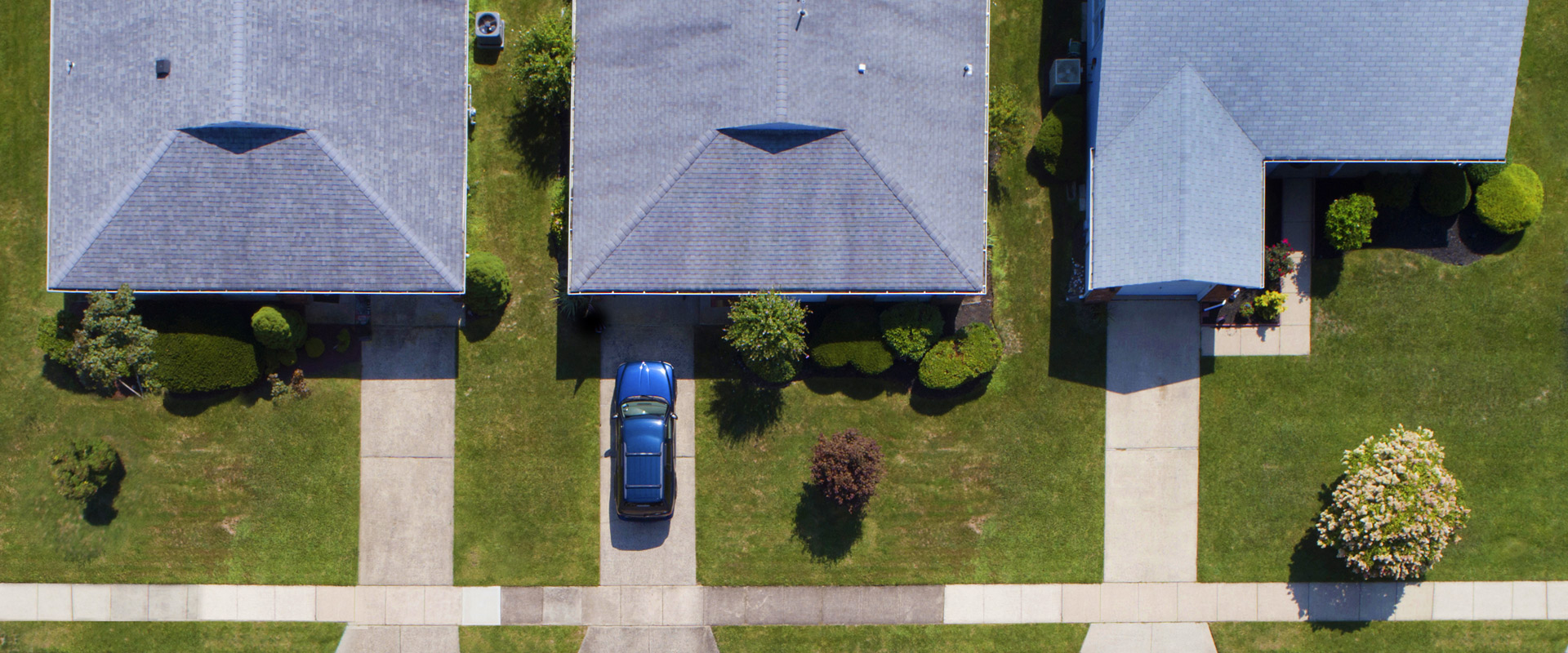 Aerial view of neighborhood of homes with drive ways lined up