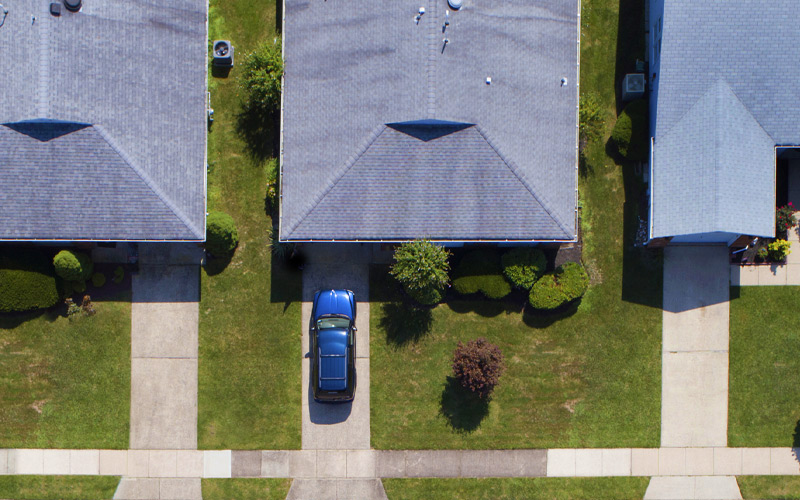 Aerial view of neighborhood of homes with drive ways lined up