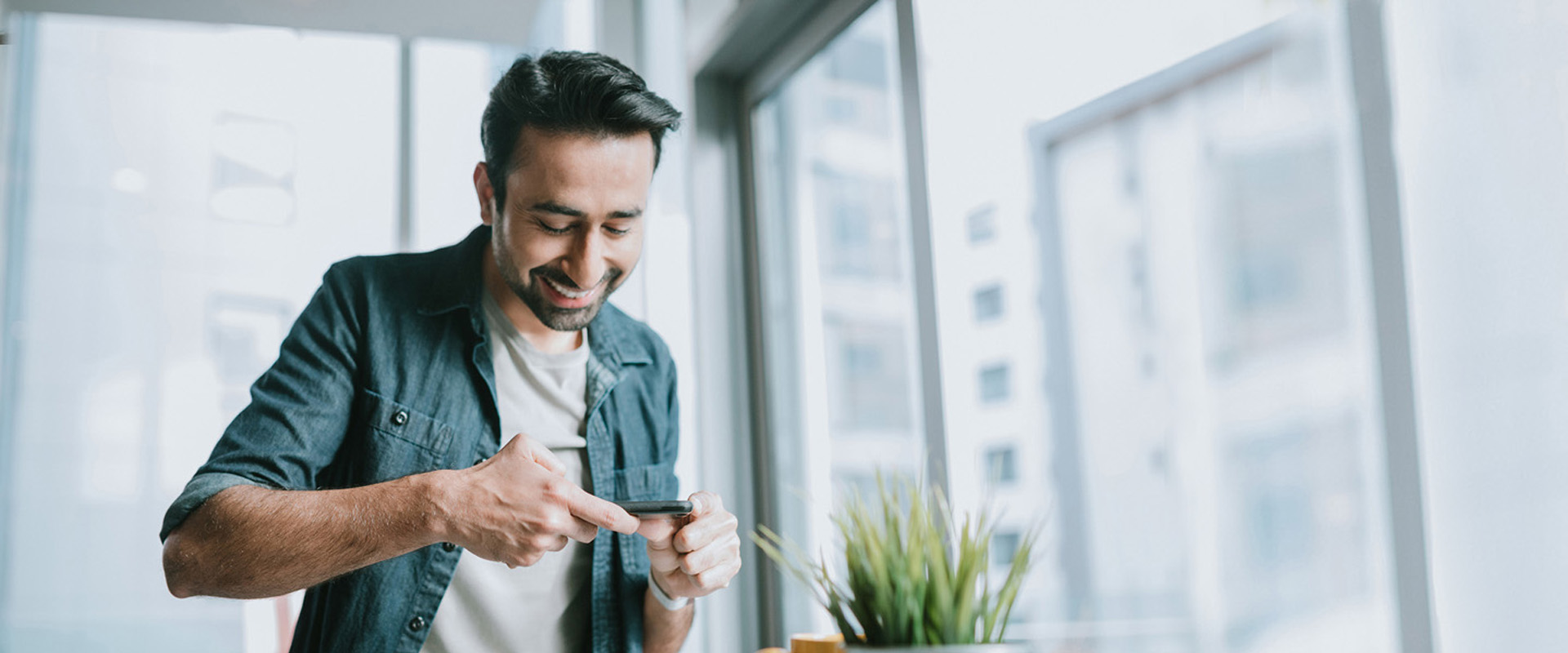 man doing banking by taking photo of a check to deposit