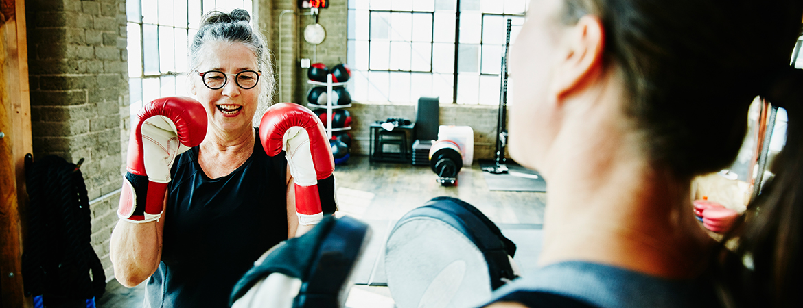 Senior woman taking a boxing class