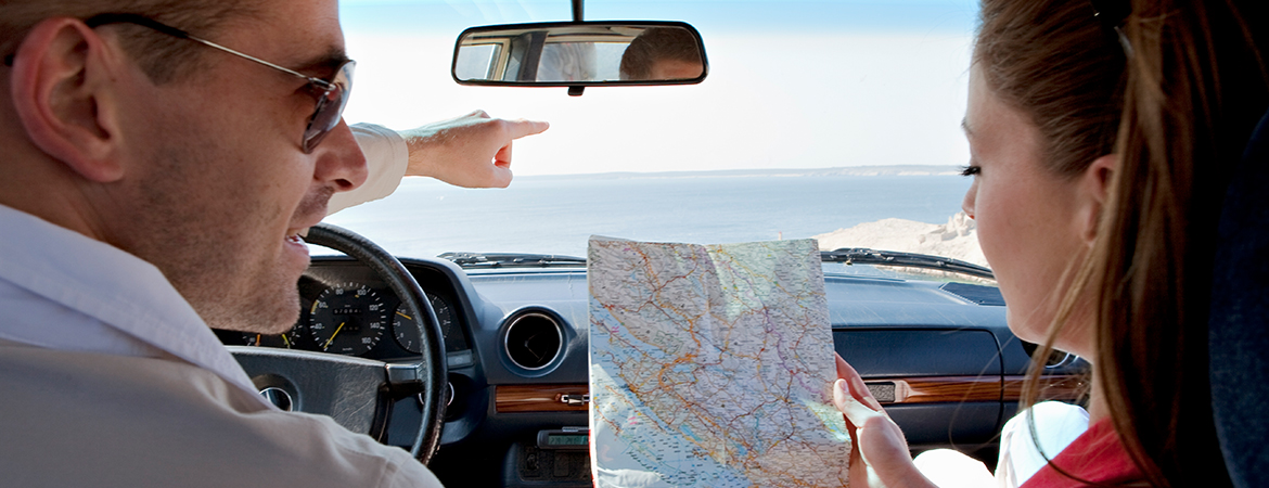 Couple looking at map on road trip