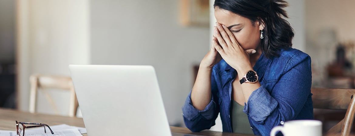 Woman looking upset while at laptop