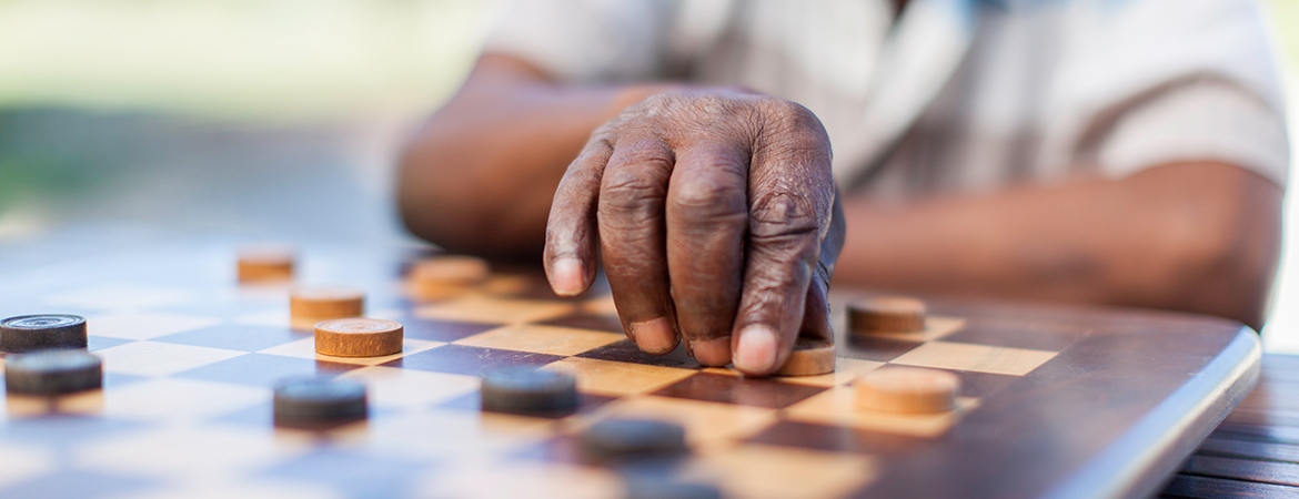 Hand of person playing checkers