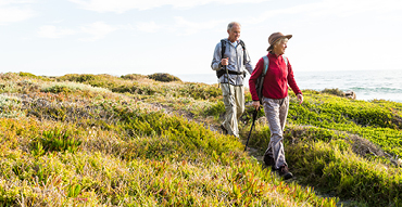 Senior couple hiking along