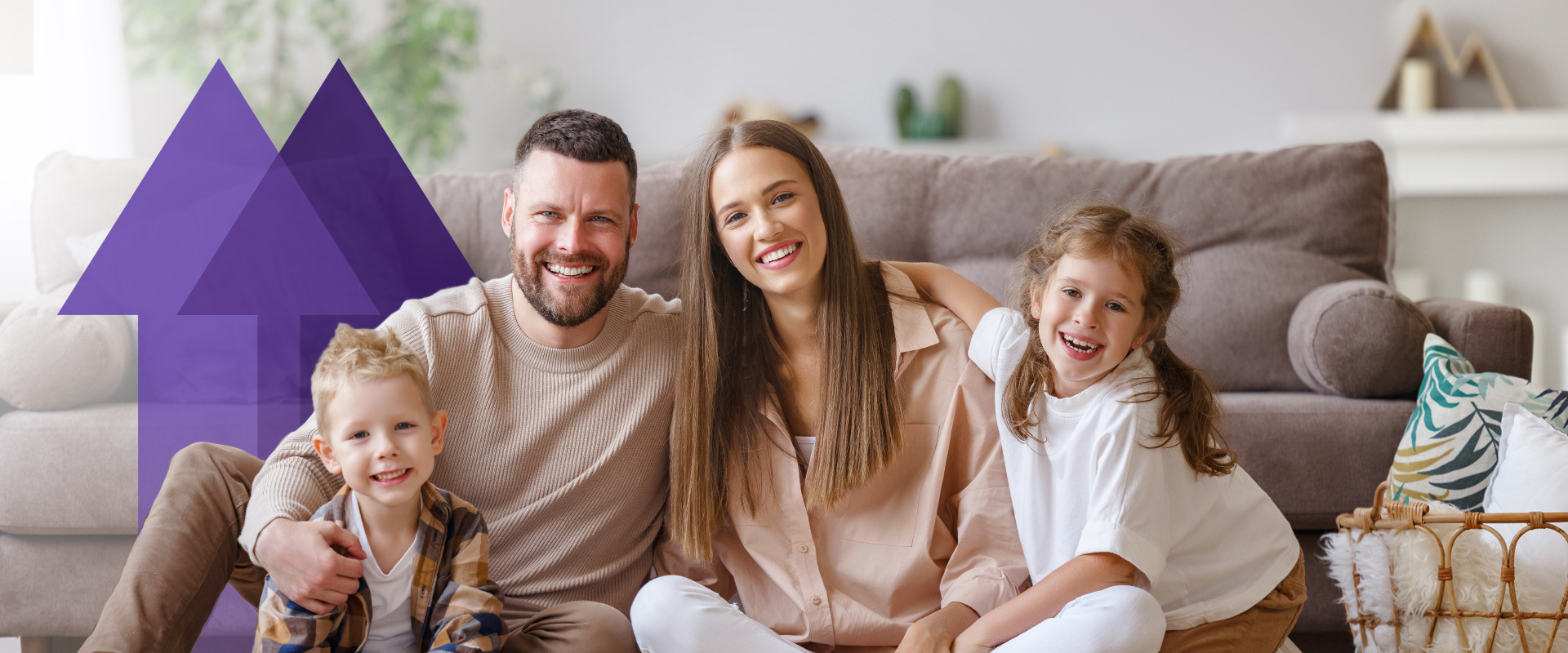 smiling parents with two young children