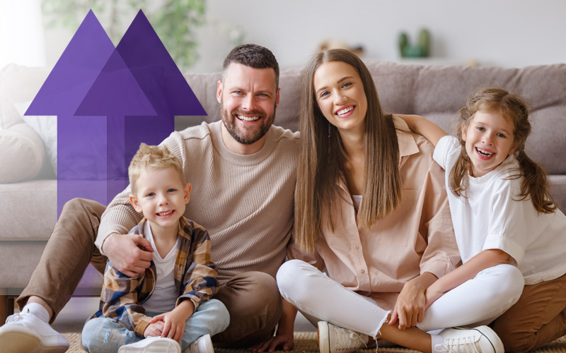 smiling parents with two young children