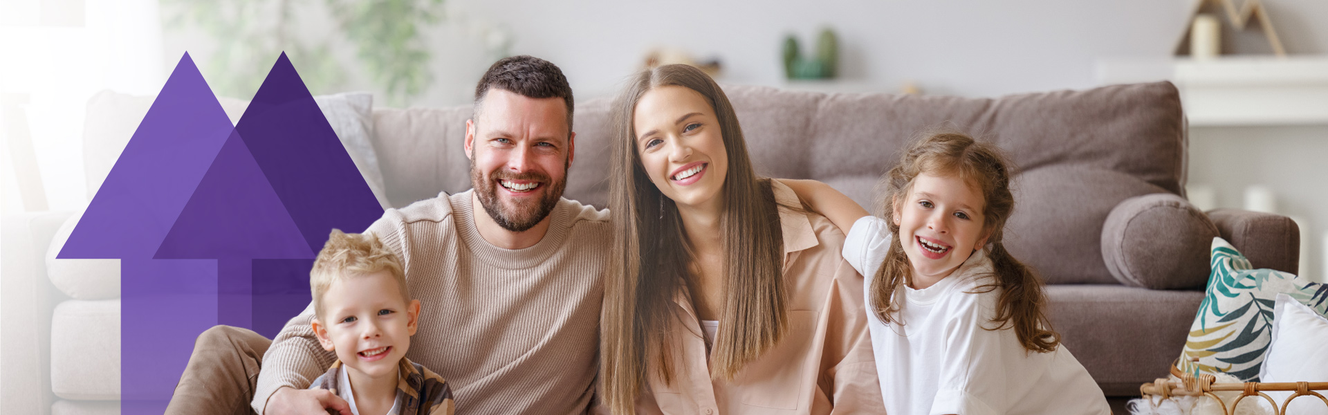 smiling parents with two young children