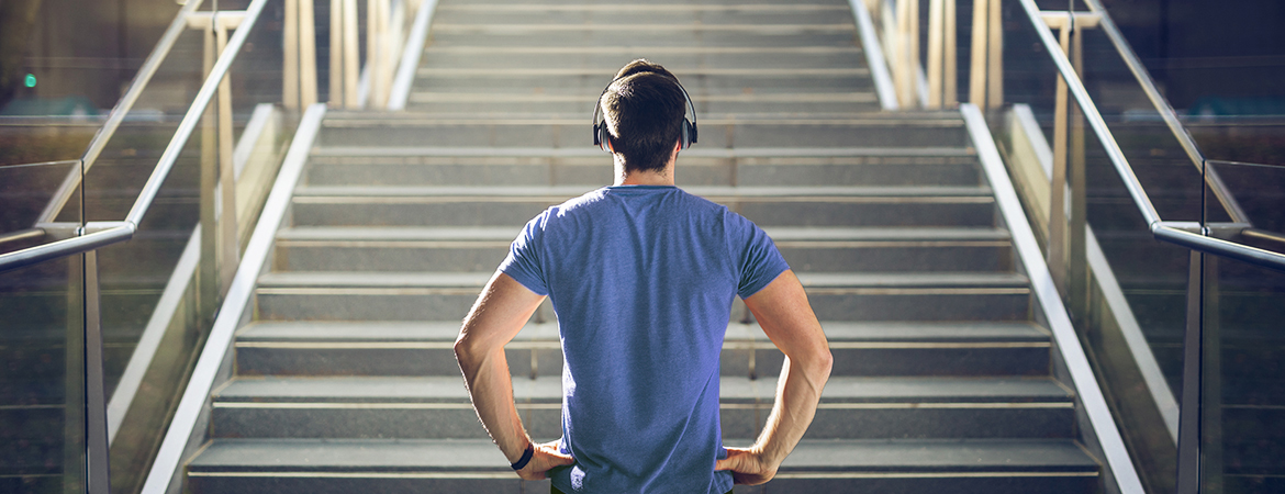 Fitness enthusiast looking at large staircase before starting climb