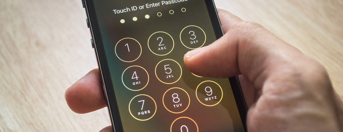 Hand entering code to unlock smartphone