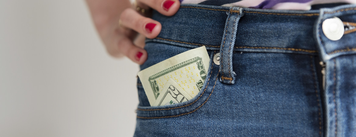 $20 bill sticking out of jeans pocket