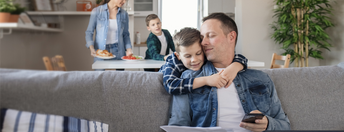 Father and son enjoying a warm hug at home